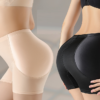 Two pairs of shaping shorts, one in nude and one in black, displayed on a mannequin from the waist down.