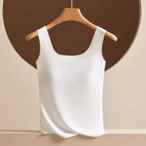 A white sleeveless top displayed on a wooden hanger against a muted background.