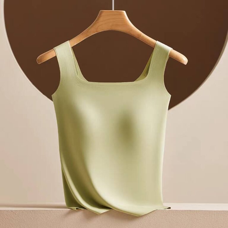 A light green sleeveless top displayed on a wooden hanger against a neutral background.
