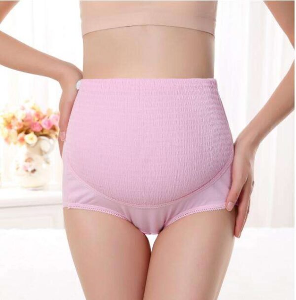 High waist maternity panty in light pink color displayed on a model's waist.