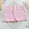 Light pink shorts with a wide waistband displayed on a tiled surface.